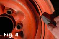 Image is a close-up view that shows how to use a utility knife to clean out the welded joints befotre priming and spray painting the wheel